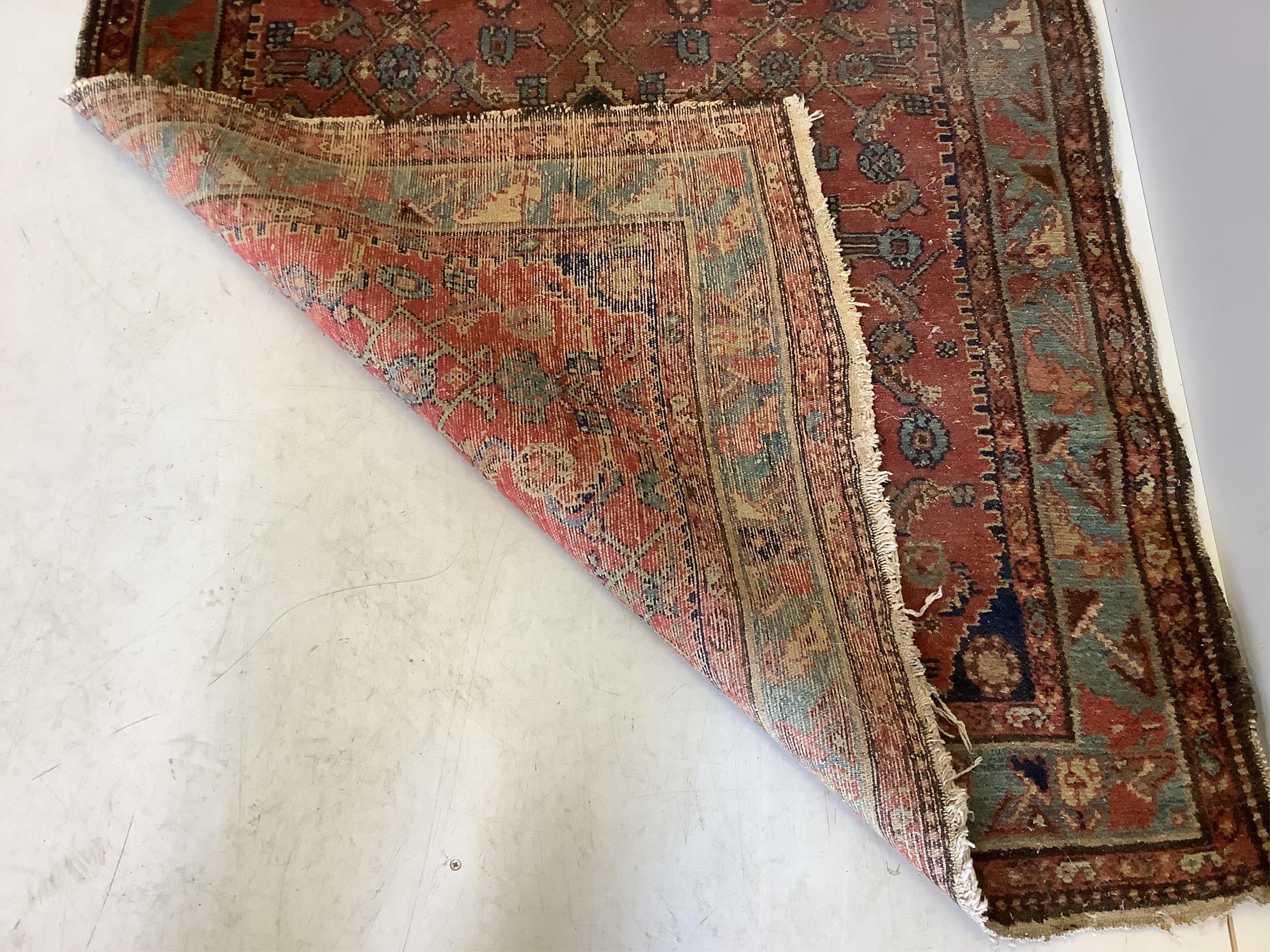 A North West Persian red ground rug, 140 x 104cm. Condition - poor-fair